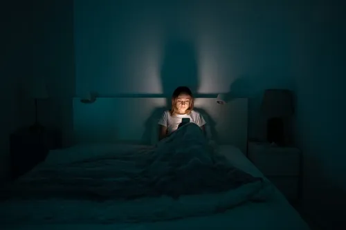 It’s tempting to look at your phone at bedtime. Unfortunately, the artificial light and mental stimulation from electronic devices are likely to keep you awake. If you’re having trouble sleeping, experts suggest reading a book, listening to relaxing music, or meditating instead. (Image via Shutterstock)