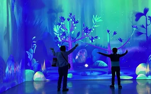 Mom and boy play with trees in Dream Garden